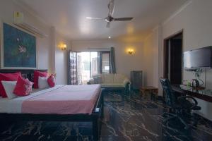 a bedroom with two beds and a ceiling fan at Perch Arbor Suites in Gurgaon