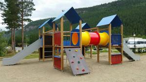 a playground with a slide and a climbing frame at Saltdal Turistsenter in Storjord
