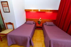 Posteľ alebo postele v izbe v ubytovaní Hostal Magnolia