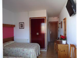 Posteľ alebo postele v izbe v ubytovaní Hostal Magnolia