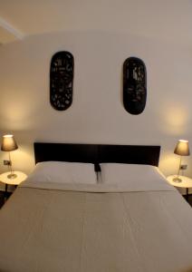 a bedroom with a bed with two lamps on the wall at Studia Letců 2A in Olomouc