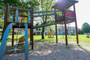 a playground with a slide in a park at Logis Le Relais De Pouilly in Pouilly-sur-Loire