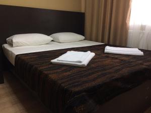 a hotel room with a bed and two nightstands at Apartment E&J in Krasnoyarsk
