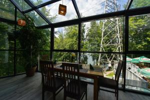 a room with a table and chairs and a ferris wheel at Hotel Posada Vidraru in Căpăţîneni-Ungureni