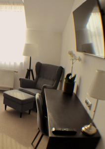 a living room with a couch and a chair and a table at Studia Letců 2A in Olomouc