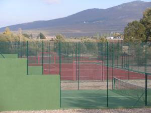 a tennis court with two tennis courts at Camping Riaza in Riaza