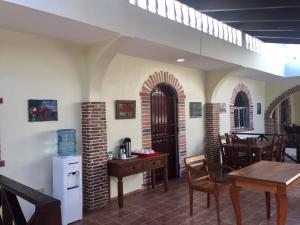 a room with a table and chairs and a kitchen at Hotel Yamilí in Punta Cana