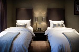 Postel nebo postele na pokoji v ubytování Castle Hotel & Apartments