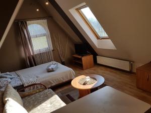 A bed or beds in a room at Pokoje Gościnne Trebunia