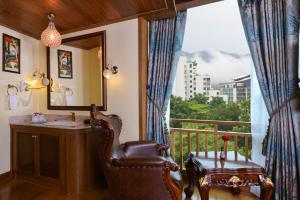 a bathroom with a balcony with a sink and a mirror at Peak Nimman Prestige Hotel in Chiang Mai