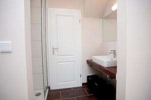 a bathroom with a sink and a white door at Ferienhaus Cuxborn 7 in Zell an der Mosel