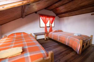 Ліжко або ліжка в номері Hostal Taita Cristobal