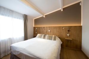 Postel nebo postele na pokoji v ubytování Hotel Le Fournil