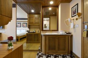 a bathroom with a sink and a bedroom at Peak Nimman Prestige Hotel in Chiang Mai +70 photos