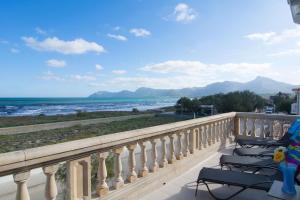 a balcony with chairs and a view of the ocean at Front Line Beach Apartment in Son Serra in Son Serra de Marina