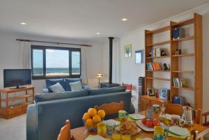 a living room with a couch and a table with fruit on it at Front Line Beach Apartment in Son Serra in Son Serra de Marina