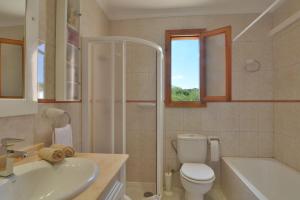 a bathroom with a toilet and a sink and a shower at Front Line Beach Apartment in Son Serra in Son Serra de Marina +29 photos