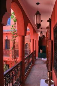 a corridor of a building with a balcony at Riad Honey in Marrakesh