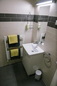 a bathroom with a sink and a mirror at Hotellux B&B in Zagreb