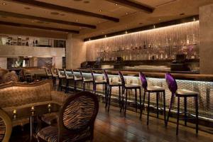 a restaurant with a bar with chairs and a counter at Luxury Suites at Palms Place in Las Vegas