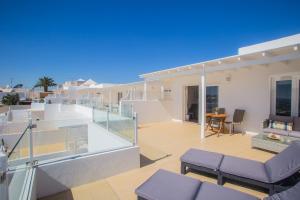 a balcony of a house with purple furniture at Flower Beach Suite 25 in Playa Honda