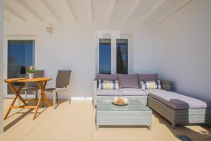 a living room with a couch and a table at Flower Beach Suite 25 in Playa Honda