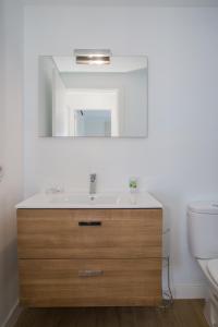 a bathroom with a sink and a mirror at Flower Beach Suite 25 in Playa Honda