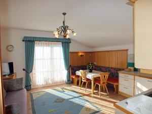 a kitchen and dining room with a table and a couch at Apartment Haus Stocker in Wagrain