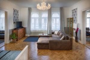 a living room with a couch and a chandelier at Veleslavinova 4 - Old Town Apartment in Prague