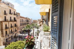 an apartment balcony with a view of a street at Palazzo Melluso LUXURY SUITE in Porto Empedocle