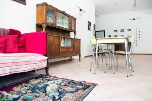 a living room with a couch and a table and chairs at Ostello Valtrebbia in Marsaglia
