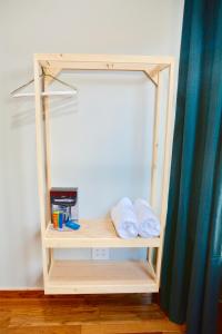 a wooden shelf with a towel hanging from it at Morris Guest House in Bronx