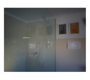 a shower in a bathroom with a glass door at La Casa di Anna G. in Alberobello