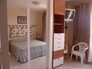 a bedroom with a bed and a dresser with a mirror at Arcoiris in Callao Salvaje +64 photos