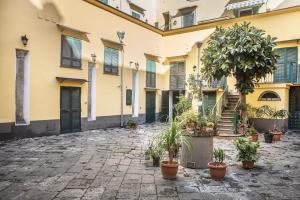 a courtyard of a building with potted plants at The Rock in Naples