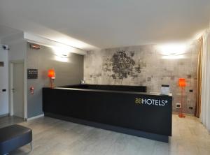 a hotel lobby with a reception desk in a room at BB Hotels Aparthotel Bicocca in Milan