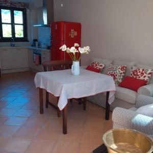 a living room with a table with a vase of flowers on it at Tu casita de la Senda del Oso in Proaza
