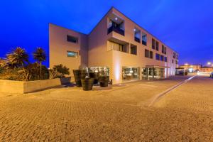 a building with a parking lot in front of it at Villa C Boutique Hotel in Vila do Conde