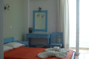 a bedroom with a teddy bear laying on a bed at Hotel Paros in Parikia