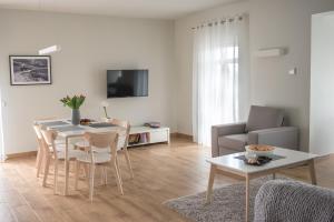 a living room with a table and a couch at METRAK Apartamenty Darlowo in Darłowo