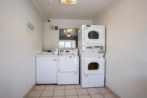 a room with three washer and dryers next to a wall at Motel 6-Prescott, AZ in Prescott