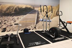 a gym with a painting of a boardwalk to the beach at Hotel-Restaurant Nordlicht in Kappeln