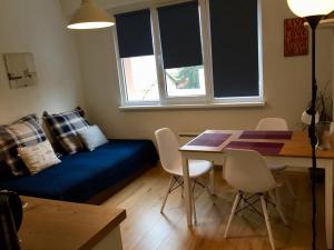 een woonkamer met een blauwe bank en een tafel bij Apartment 17 in Velingrad