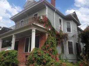a house with a balcony with flowers on it at Evangeline Art House in New Orleans