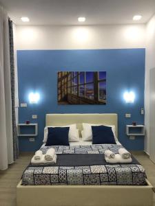 ナポリにあるDecumani Prestigeの青い壁のベッドルーム1室(大型ベッド1台付)