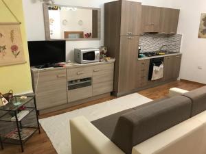 a living room with a couch and a kitchen at La Piazzetta in Austis