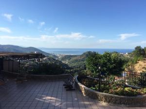a patio with benches and a view of the ocean at La vecchia fattoria in Salerno