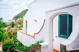 
a small white building with a blue wall at Eden House Positano in Positano
