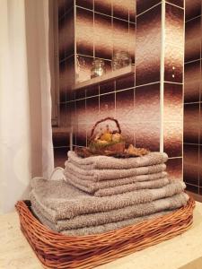 a pile of towels in a basket in a bathroom at Provence style apartment in Košice