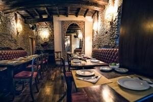 a restaurant with long tables and chairs and a mirror at Hotel Antica Locanda in Rome